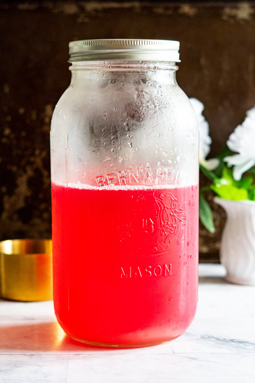 Rhubarb juice in a half gallon jar. 