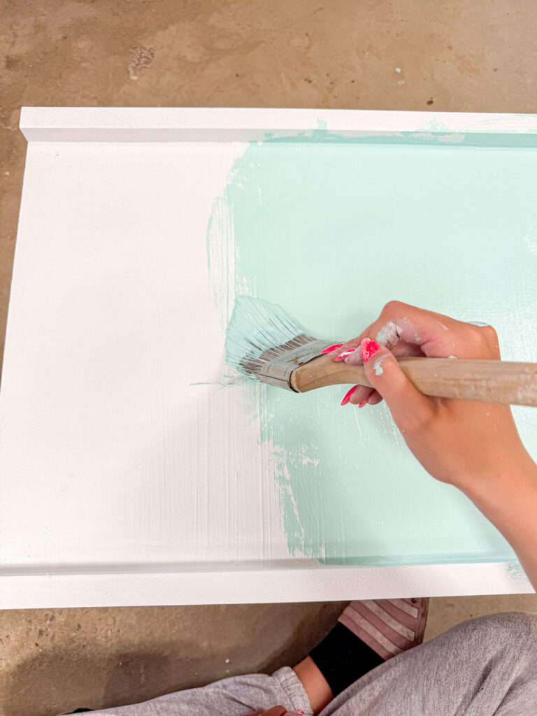 Painting the underside of the bottom board.