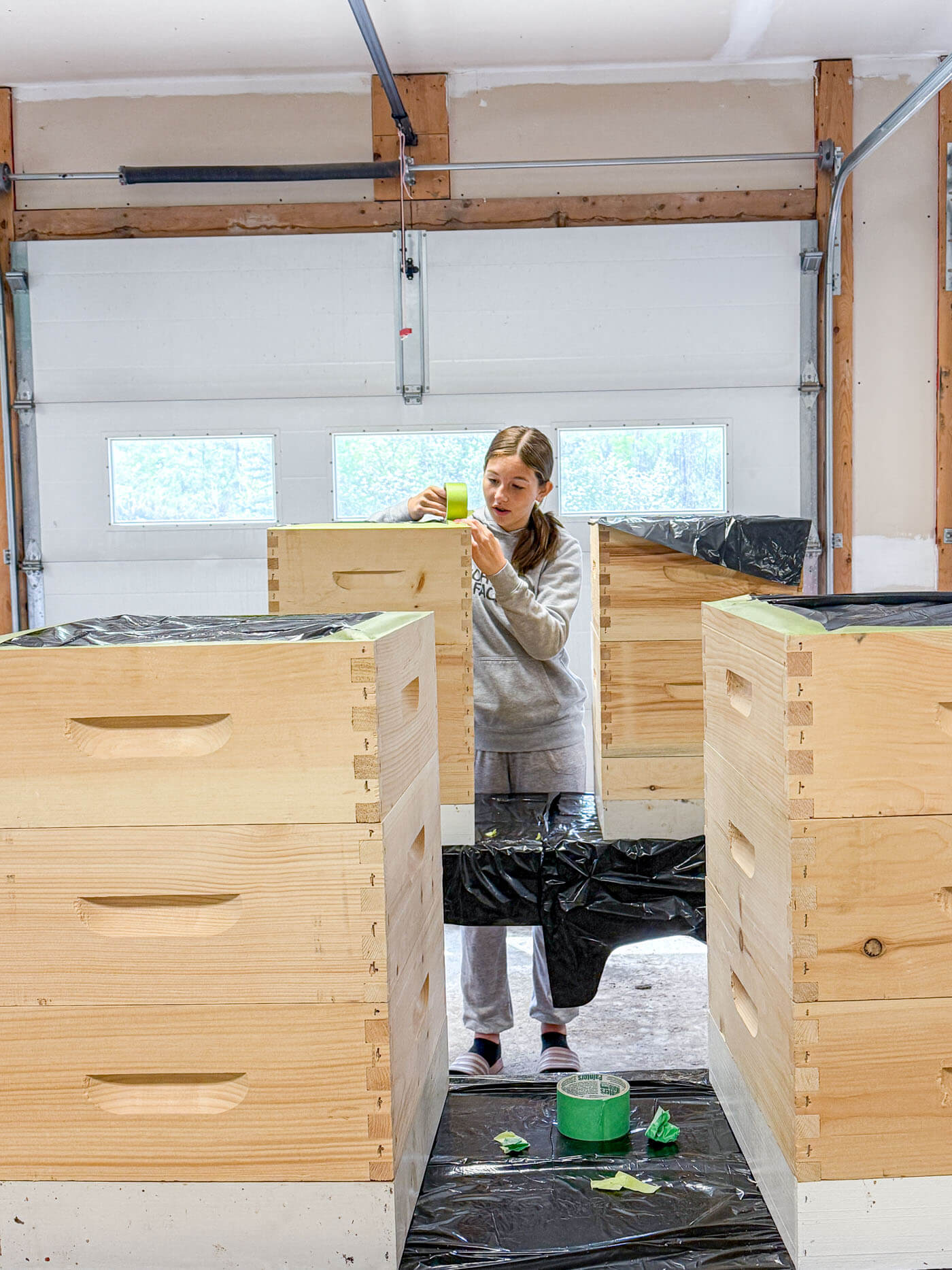 Covering the edge of the hives with painters tape and garbage bags.
